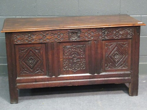 Lot 703 - An oak coffer with three panel front dated...