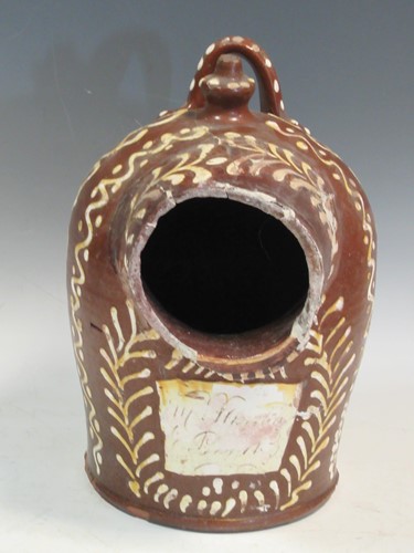 Lot 65 - A 19th century slipware salt cellar 29cm high