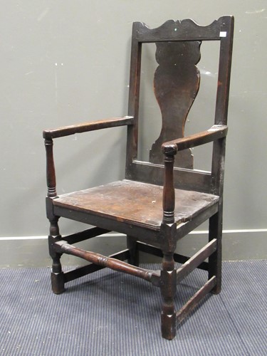 Lot 673 - An 18th century Welsh oak armchair with shaped...