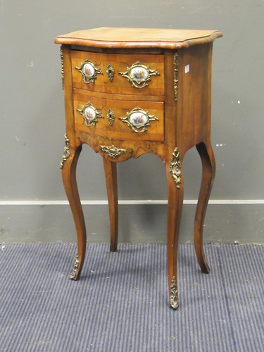 Lot 604 - A French walnut petit commode of serpentine...