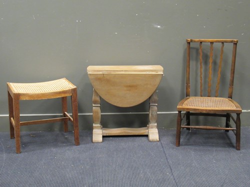 Lot 638 - A limed oak small drop leaf table in the...
