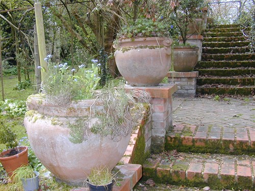 Lot 974 - Four terracotta coloured reconstituted stone urns, 20th century