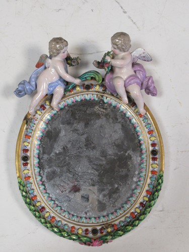 Lot 34 - A continental porcelain mirror, mounted with...