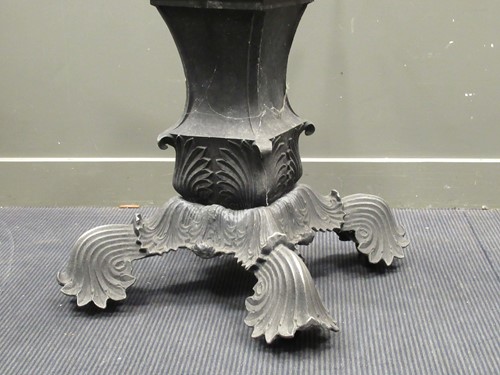 Lot 560 - A modern table with a slate top, the base cast...