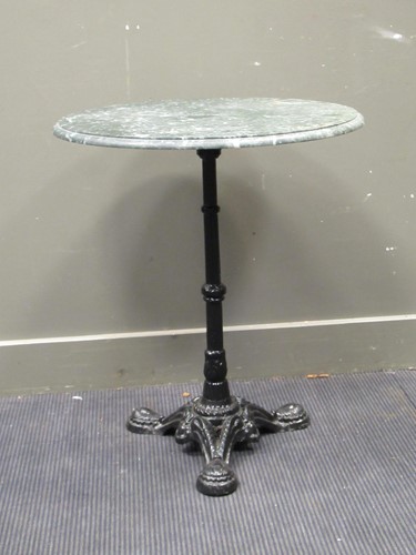 Lot 655 - A modern cast iron table with a marble top 75...