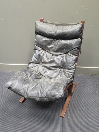 Lot 687 - An Eames style black leather chair with...