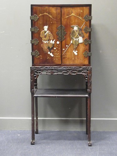 Lot 471 - A Japanese lacquer cabinet with decorated...