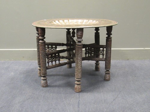 Lot 668 - An Indian polished brass top occasional table,...