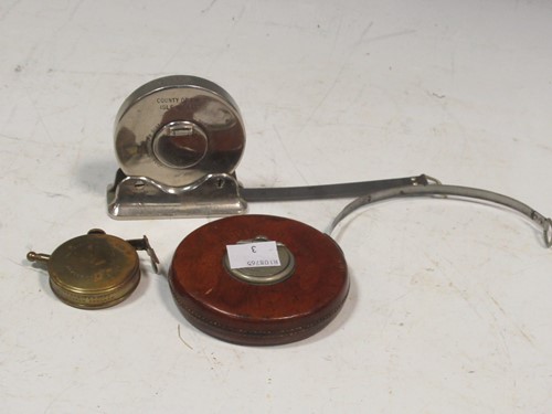 Lot 154 - Three steel tape measures, by Chesterman (66...
