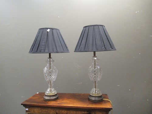 Lot 656 - A pair of cut glass lamp bases, with shades