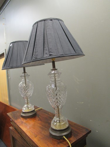 Lot 656 - A pair of cut glass lamp bases, with shades