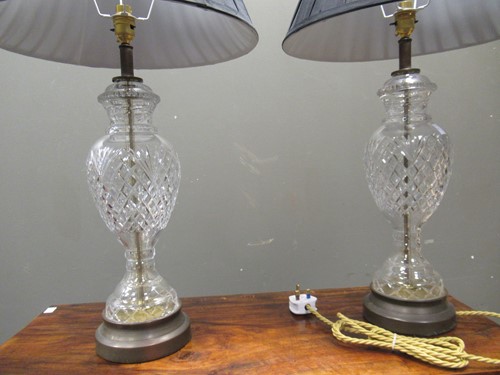 Lot 656 - A pair of cut glass lamp bases, with shades