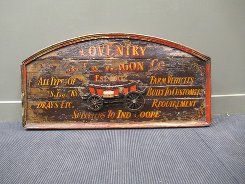 Lot 538 - A painted wood arched advertising sign with...