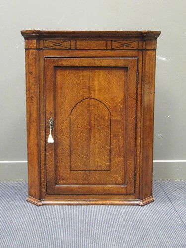 Lot 548 - A George III inlaid oak corner cupboard 103 x...