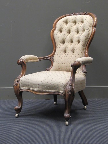 Lot 667 - A late Victorian walnut button back arm chair...