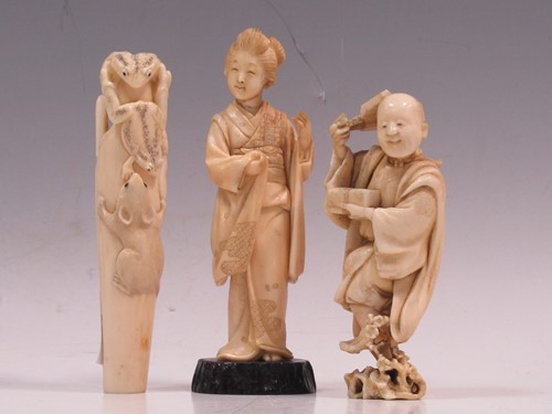 Lot 136 - An ivory parasol handle carved with a rat and...