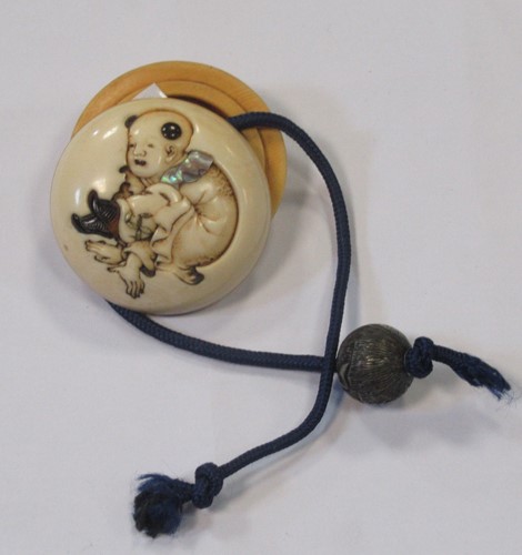 Lot 134 - An ivory and mother of pearl manju netsuke, in...