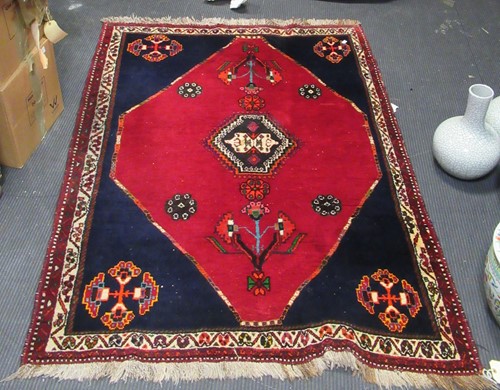 Lot 782 - A red ground woolen rug 174 x 126cm