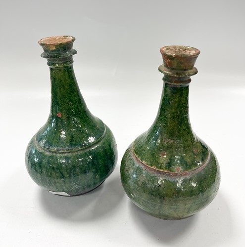 Lot 98 - A pair of Turkish Ottoman green glazed pottery ewers