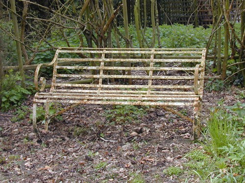 Lot 975 - A Victorian painted iron strap work garden seat