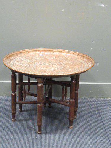 Lot 583 - A Middle eastern copper tray on folding stand,...