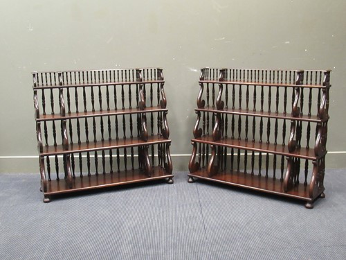Lot 614 - A pair of Georgian style mahogany four tier...