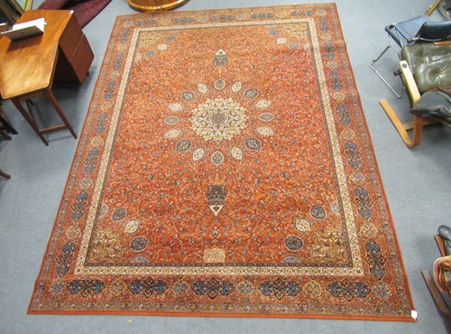 Lot 597 - A modern orange ground carpet with central...
