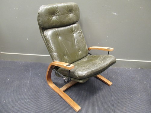 Lot 686 - An Eames style green leather reclining armchair