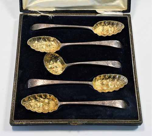 Lot 479 - Four George III 18th century silver tablespoons with later decoration and a sifting spoon en suite