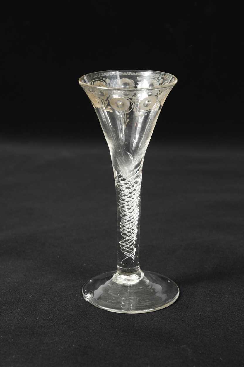 Lot 443 - A rare George II trick wine glass, circa 1740
