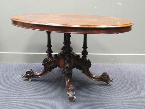 Lot 569 - A Victorian figured walnut and inlaid oval loo...