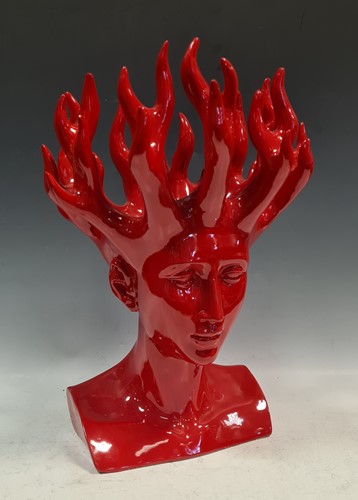 Lot 103 - A red resin Nordic head