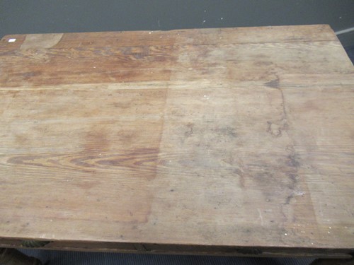 Lot 572 - A pine drop leaf table with two drawers on...