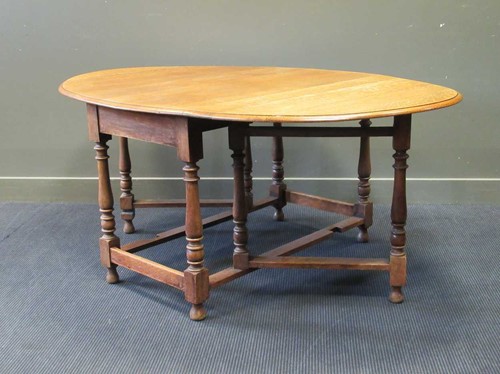 Lot 586 - An large Victorian oak drop leaf dining table...