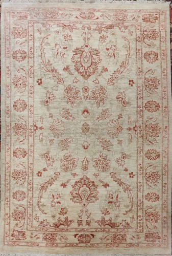 Lot 511 - A Persian cream ground rug with red foliate...