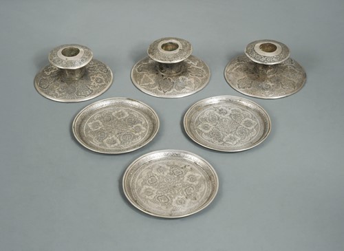 Lot 464 - Three early 20th century Iranian metalwares silver dwarf candlesticks together with three coasters