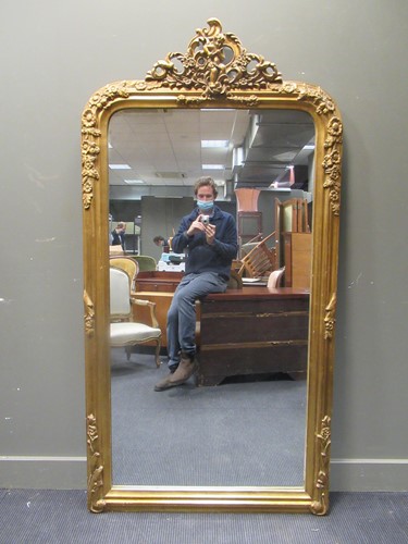 Lot 529 - A gilt modern framed overmantle mirror...
