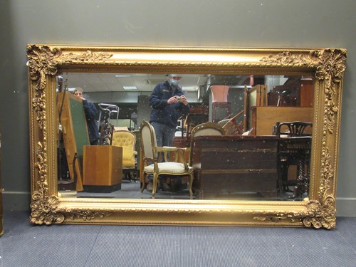 Lot 530 - A large rectangular gilt wall mirror with...