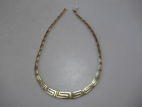 Lot 189 - A Greek key design necklet, stamped 'K14',...