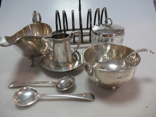Lot 214 - A collection of silver items including toast...