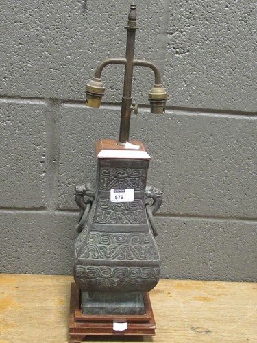 Lot 579 - A bronze lamp base of Chinese archaic form,...