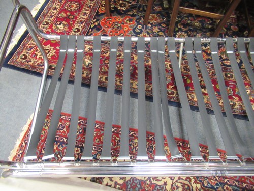 Lot 632 - Chrome tubular sofa with white striped...