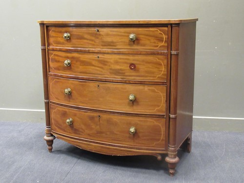 Lot 570 - A Regency mahogany and inlaid bowfront chest...