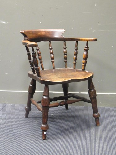 Lot 489 - A Victorian ash and elm smokers bow armchair...