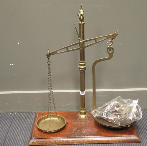 Lot 147 - Two early 20th century brass sets of scales on...