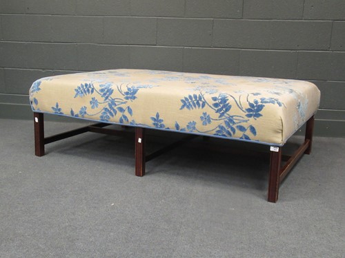 Lot 555 - A large upholstered ottoman seat on legs with...