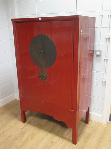 Lot 559 - A Korean red-stained wood two door cupboard,...