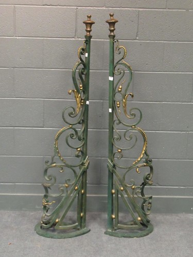 Lot 554 - A pair of painted and parcel gilt wrought iron...