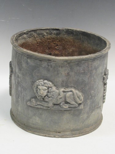 Lot 772 - A Circular lead planter decorated with foliate...