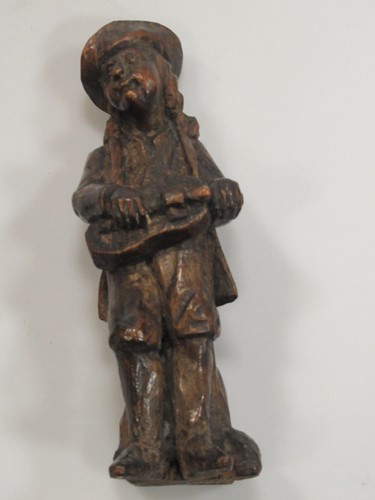 Lot 70 - A carved oak figure of a hurdy-gurdy player,...